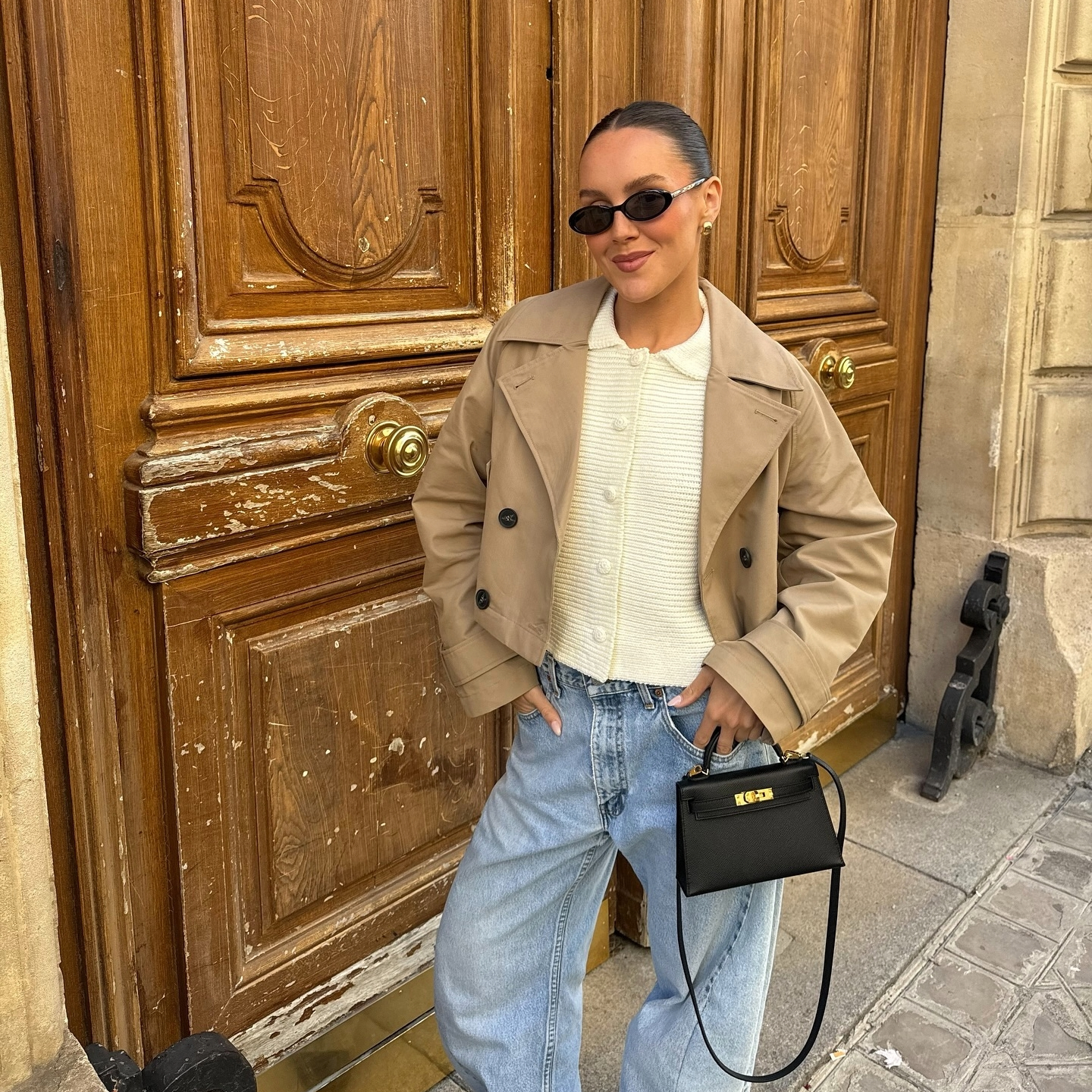 Emma Leger in a cropped trench coat in Paris